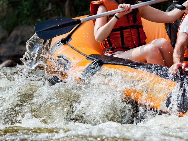 Group of people rafting in white water rapids