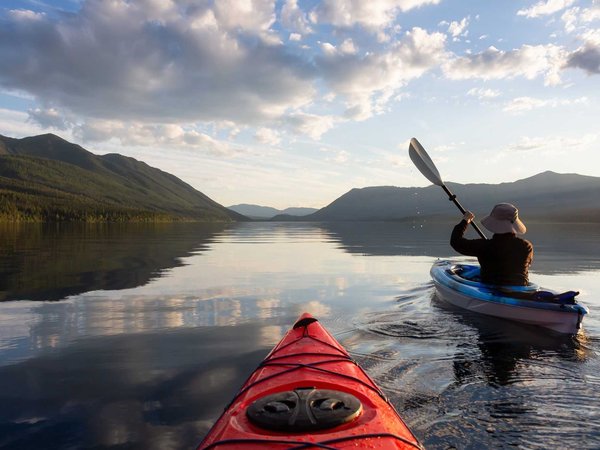 Adventurous Man Kayaking in Lake McDonald