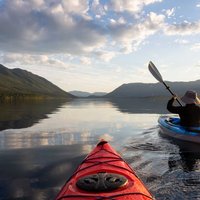 Adventurous Man Kayaking in Lake McDonald