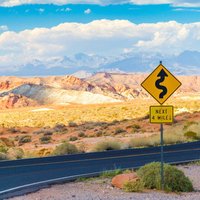 Winding road with signs in Valley of Fire State Park, Nevada