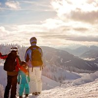 Happy family in winter clothing at the ski resort, winter time