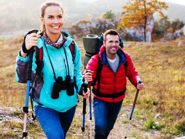 A couple finding peace and wellness on a hike in the fall