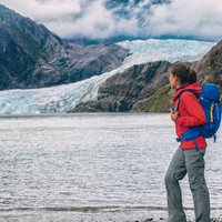 Alaska glacier tourist lifestyle in Juneau. Famous Mendenhall ice landscape summer travel destination. Cruise ship attraction.
