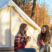 Two women prepared to enjoy a well deserved glamping trip