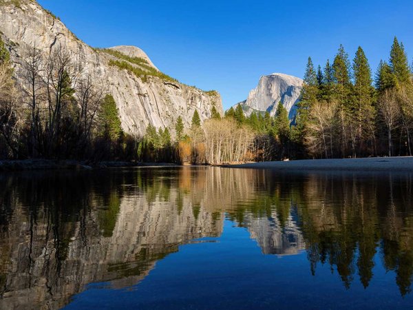 Sunny view of the half dome and merced river landscape of Yosemi