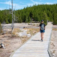 Hiker at Norris geyser basin area at Yellowstone National Park (USA)