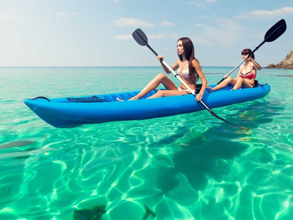 Tourists on a kayak rental enjoy crystal clear waters off Hawaii's coast