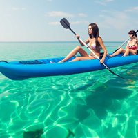 Tourists on a kayak rental enjoy crystal clear waters off Hawaii