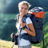 A happy hiker who is prepared with a full pack