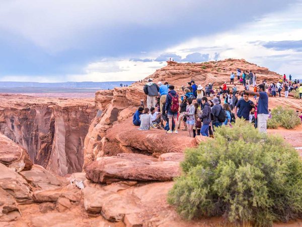 PAGE, ARIZONA - MAY 25: Hikers at Horseshoe Bend on May 25, 2015 in Page AZ,USA. Thousands of people from all over the world  visit this unique place every year.