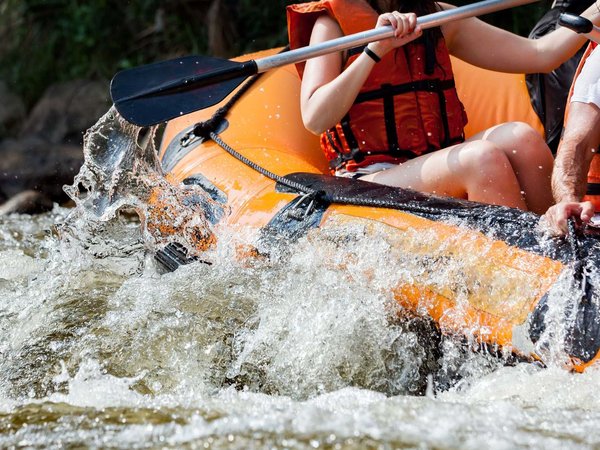 Young person rafting on the river, extreme and fun sport at tourist attraction