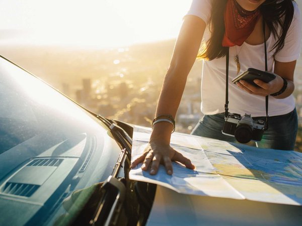 Stefanie checks the map and her phone for the next best place to stop on her road trip