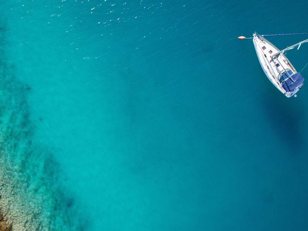 A sailboat anchored off the coast of Maui