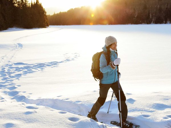 Winter hiking sport activity woman snowshoeing