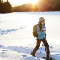 Winter hiking sport activity woman snowshoeing