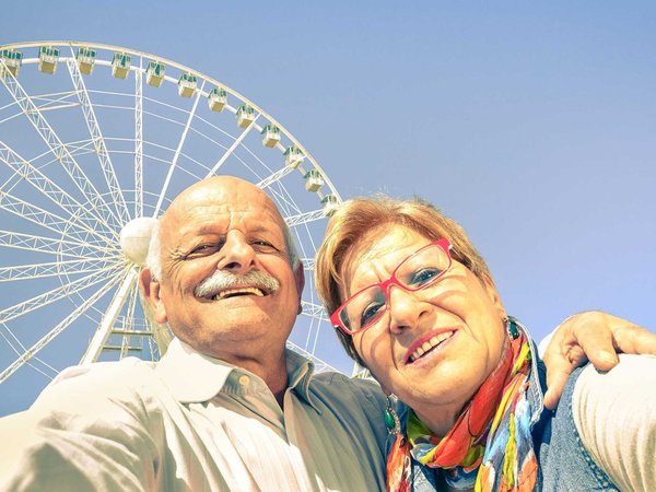 Happy retired senior couple taking selfie at travel around the w