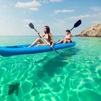 Tourists on a kayak rental enjoy crystal clear waters off Hawaii's coast