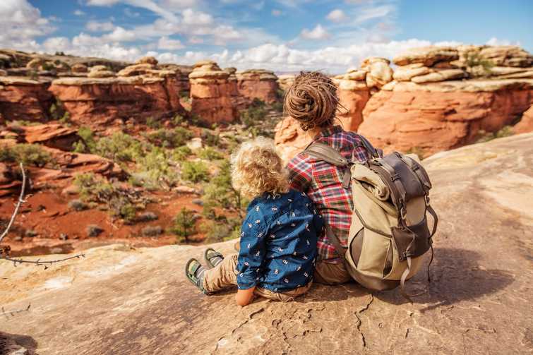 Hiker with boy in Canyonlands National park, needles in the sky, in Utah, USA