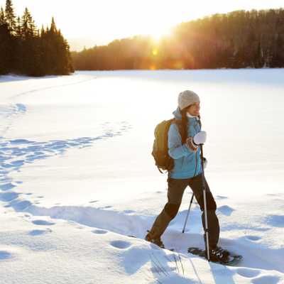 Winter hiking sport activity woman snowshoeing