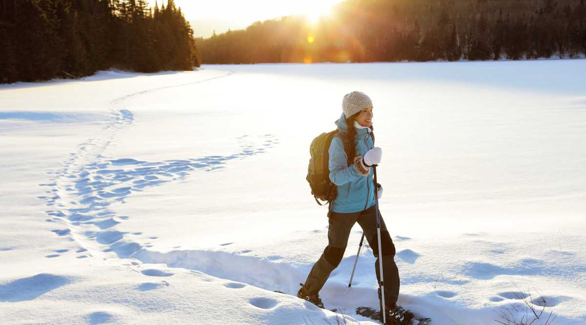 Winter hiking sport activity woman snowshoeing