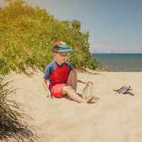 Boy sitting on a dune at Indiana Dunes National Park, Chicago sk