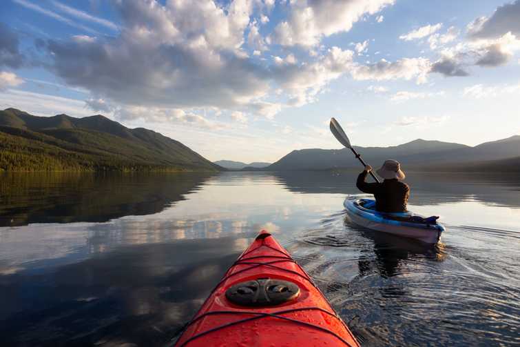 Adventurous Man Kayaking in Lake McDonald