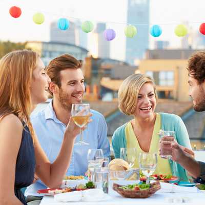 Friends enjoy a dinner while on a culinary trip.