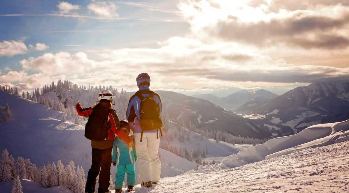 Happy family in winter clothing at the ski resort, winter time