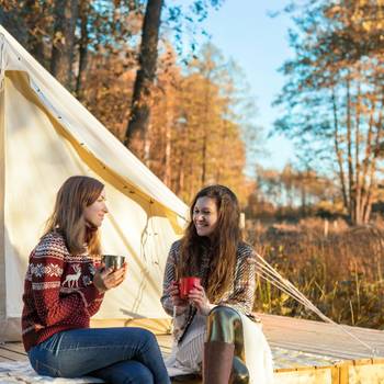 Two women prepared to enjoy a well deserved glamping trip