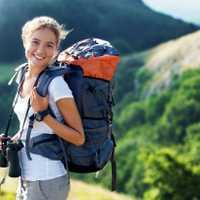A happy hiker who is prepared with a full pack