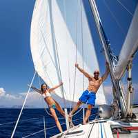 Two adventure seekers rent a boat for the day and sail in the calm ocean