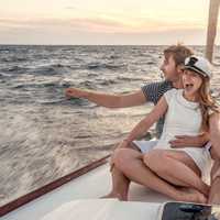 A couple enjoying the rush of wind and water on a Hawaiian boat charter